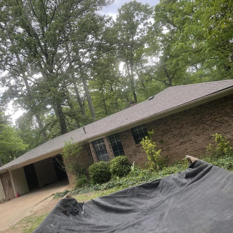 Asphalt shingle roof on brick house with yard cover