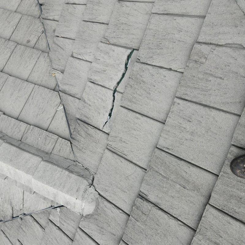 Concrete tile roof with cracked tile and wiring