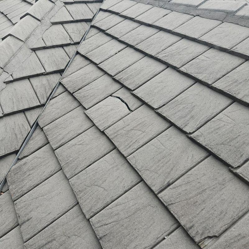Concrete tile roof with cracked and damaged tiles