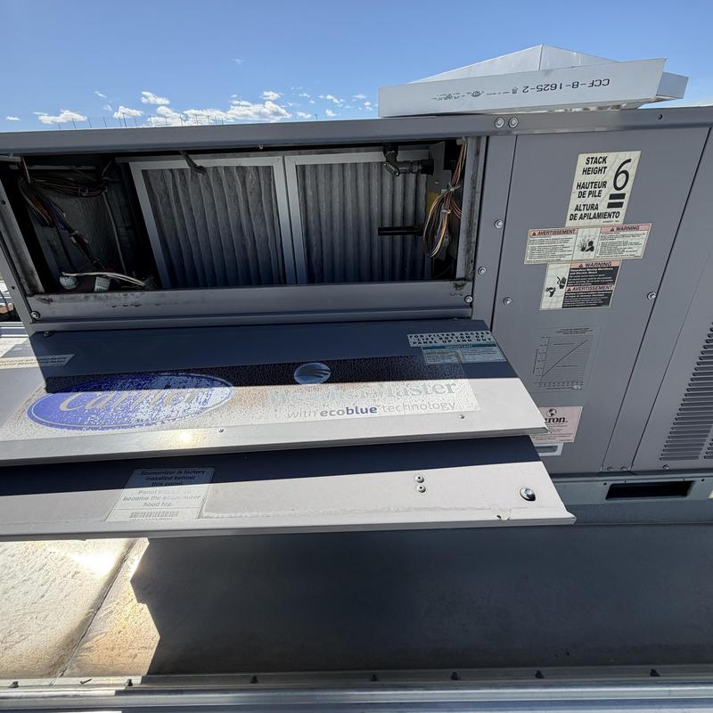 Commercial rooftop HVAC unit with open panel