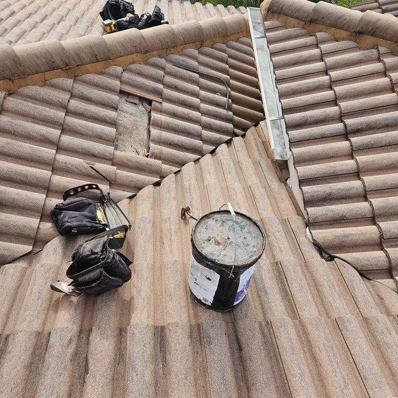 Concrete tile roof with removed damaged decking section
