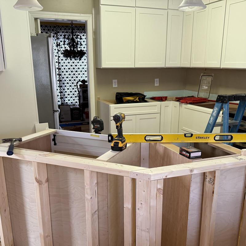 Kitchen island framing with level and drill in progress Kitchen island framing with level and drill in progress