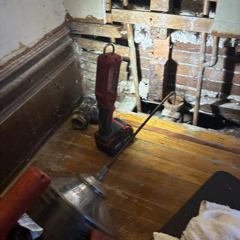 Drain line cabling tool and work area with exposed wall
