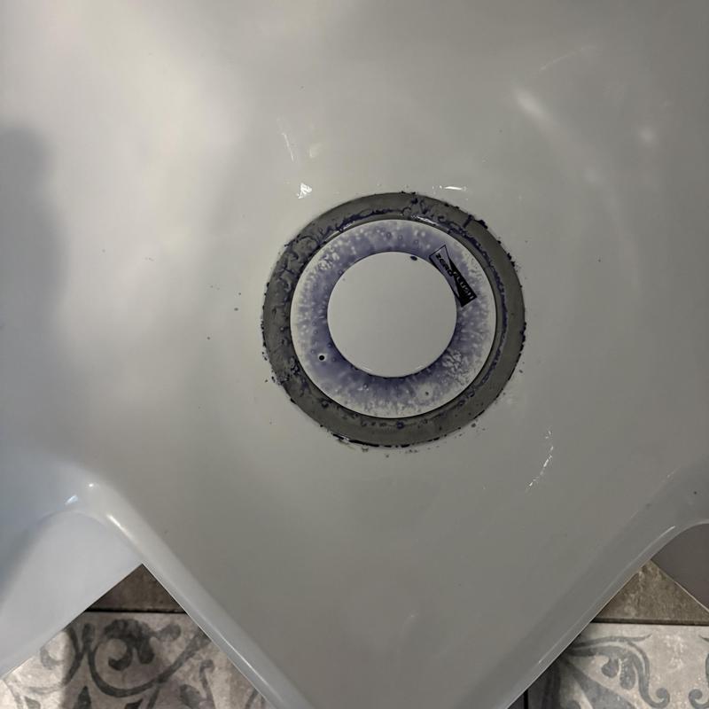 Waterless urinal cartridge installed in commercial restroom