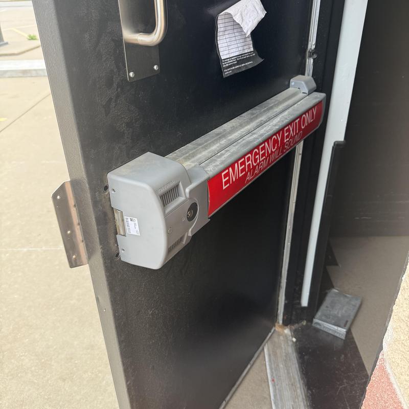 Von Duprin exit device on black door