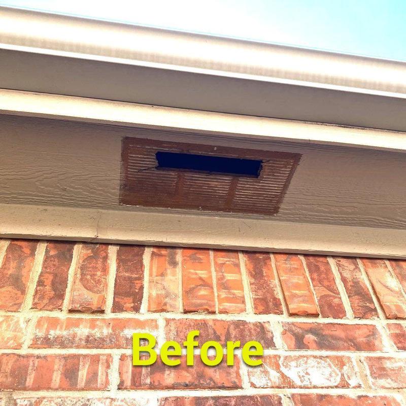 Soffit vent with damaged vent cover on brick home exterior