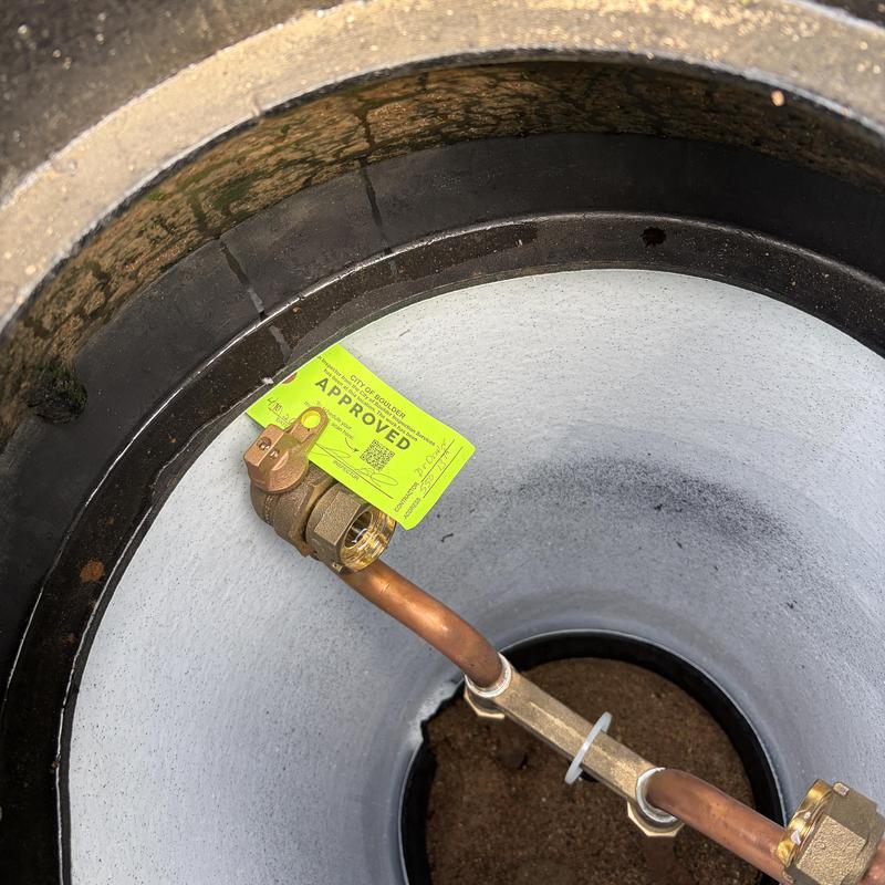 Copper water tap with meter pit and approval tag