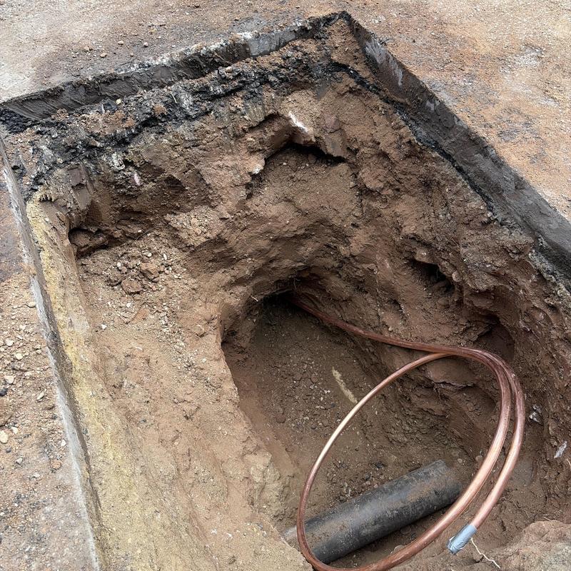 1-inch copper water tap line in excavation pit