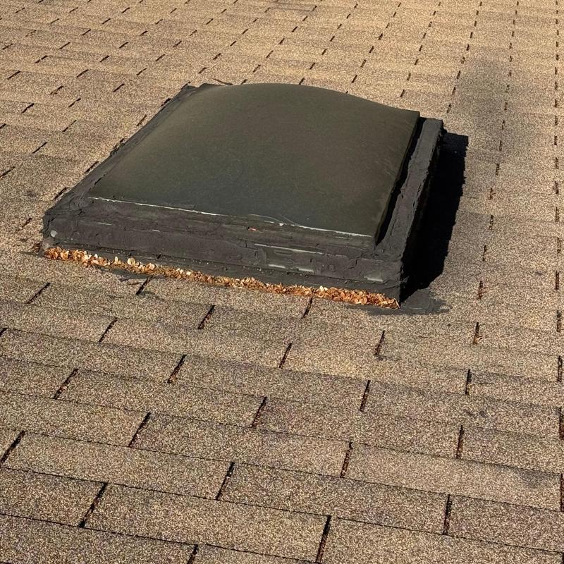 Roof skylight with sealed edges on asphalt shingles