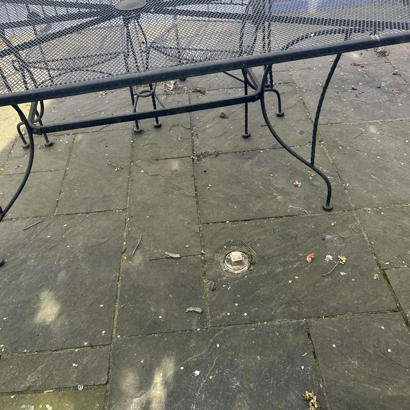 Gas line inspection cap on outdoor patio tiles