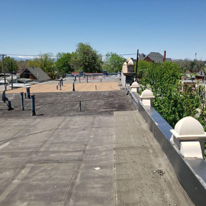 Modified bitumen flat roof showing wear and repairs Modified bitumen flat roof showing wear and repairs