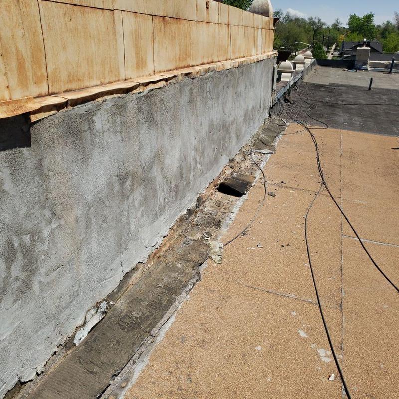 Modified bitumen flat roof with damaged wall flashing Modified bitumen flat roof with damaged wall flashing