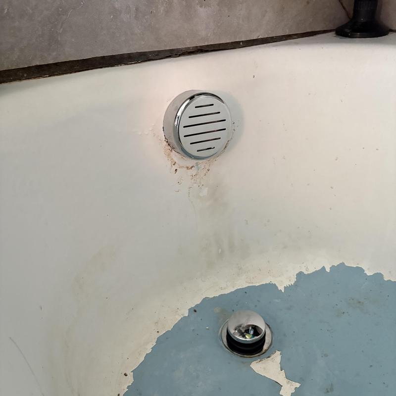 Tub drain with chrome toe tap and peeling paint