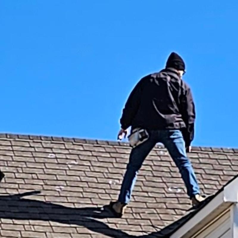 Roof shingles with hail damage inspection on residential roof