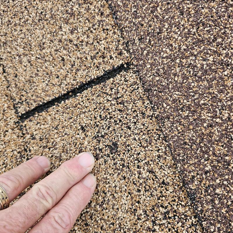 Asphalt roof shingles with hail damage close-up