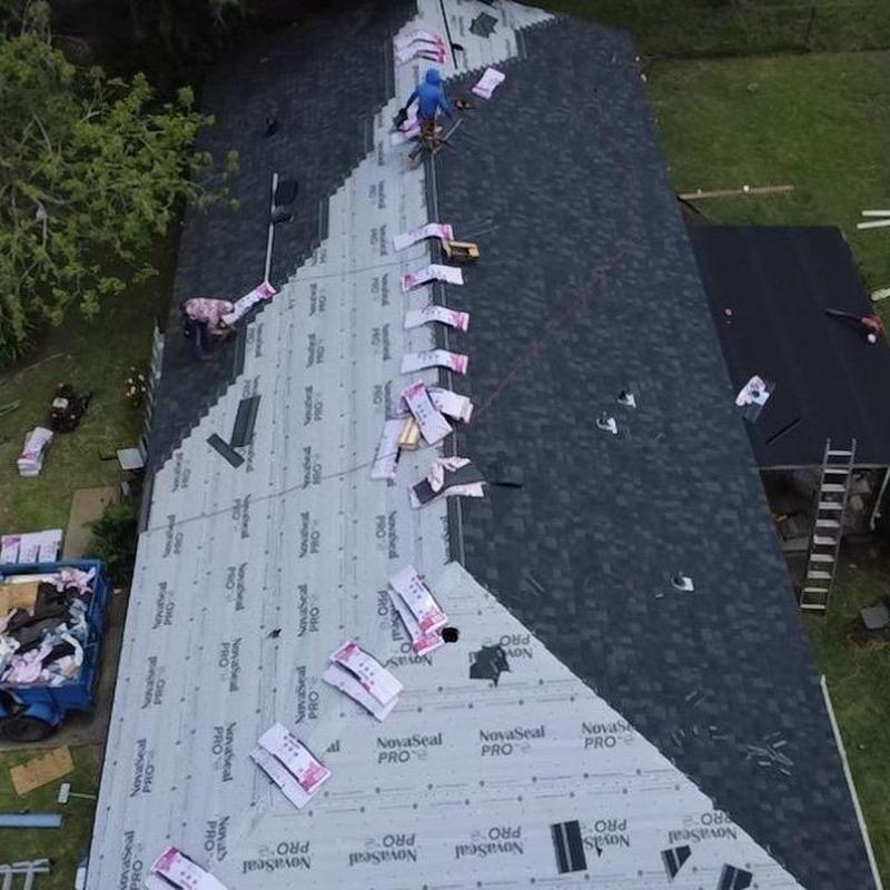 Synthetic roofing underlayment and shingle installation in progress Synthetic roofing underlayment and shingle installation in progress