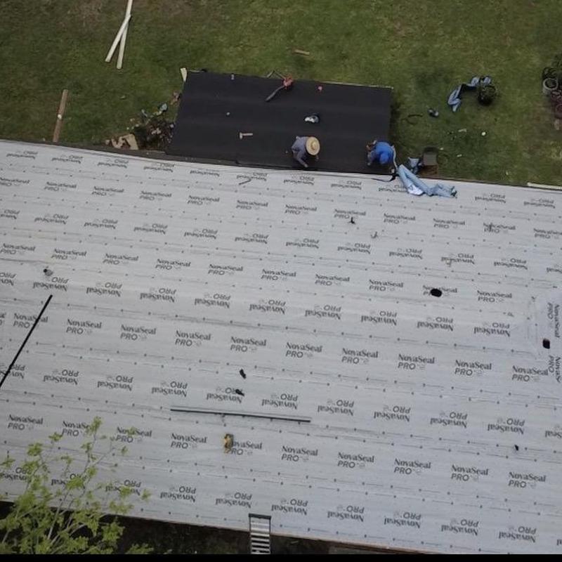 Torch down roofing installation on flat roof section Torch down roofing installation on flat roof section