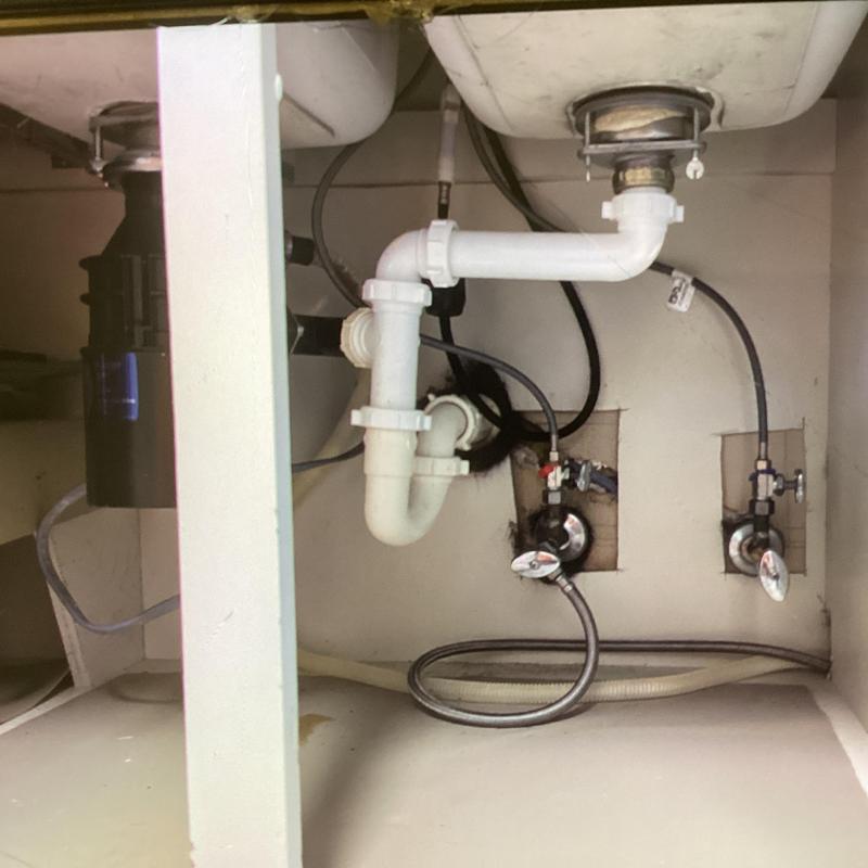 Garbage disposal and sink drain plumbing under cabinet