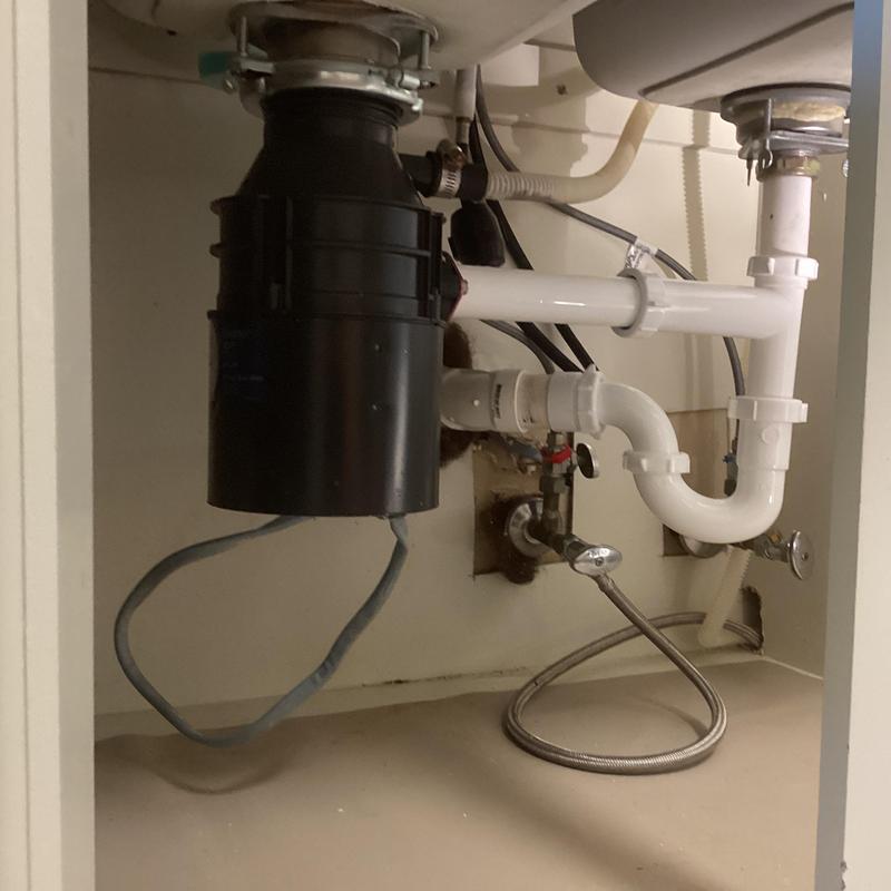 Garbage disposal and sink drain plumbing under cabinet