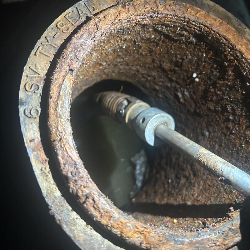 Main sewer line inspection with cleaning tool in rusty pipe