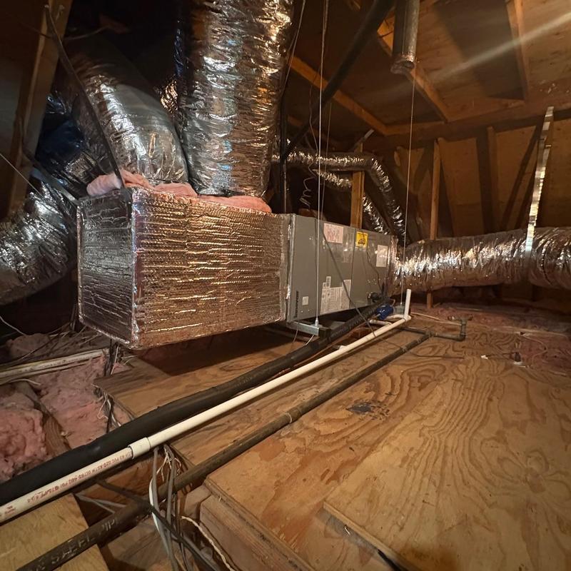 Heat pump unit with insulated ductwork in attic