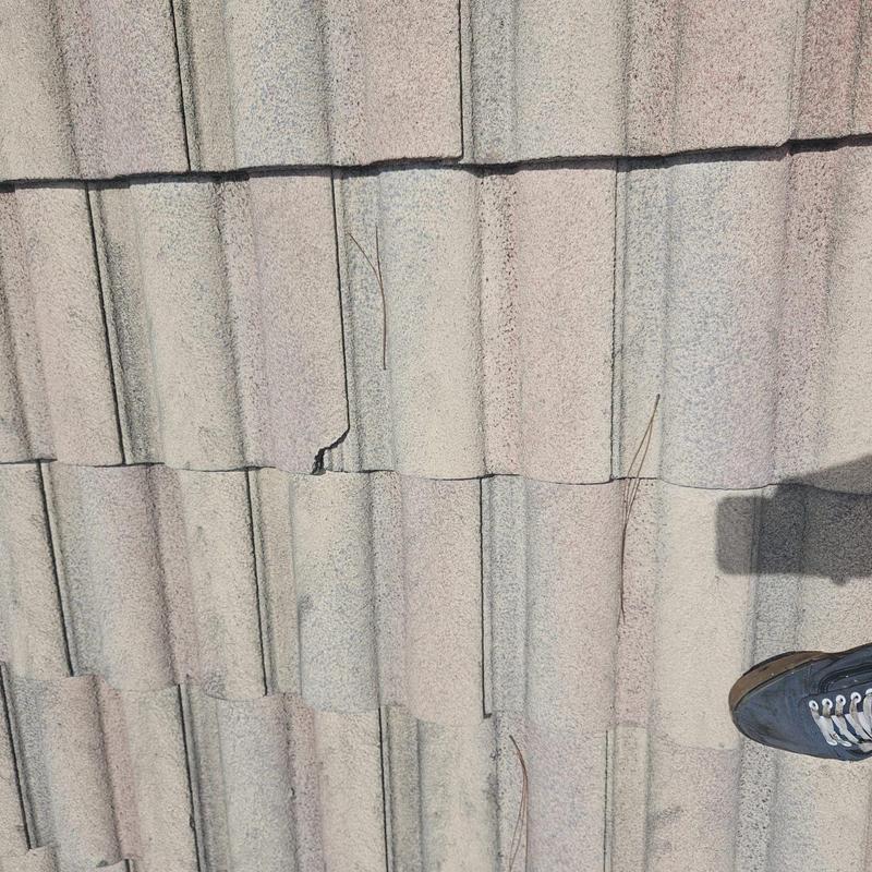 Concrete tile roof with cracked and chipped tiles