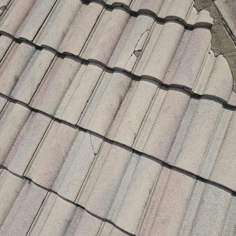 Concrete tile roof with cracked and broken tiles