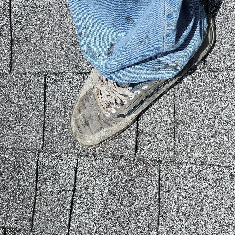 Shingle roof with worn and damaged areas underfoot