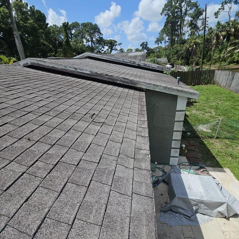 Shingle roof with wear and soft spots visible