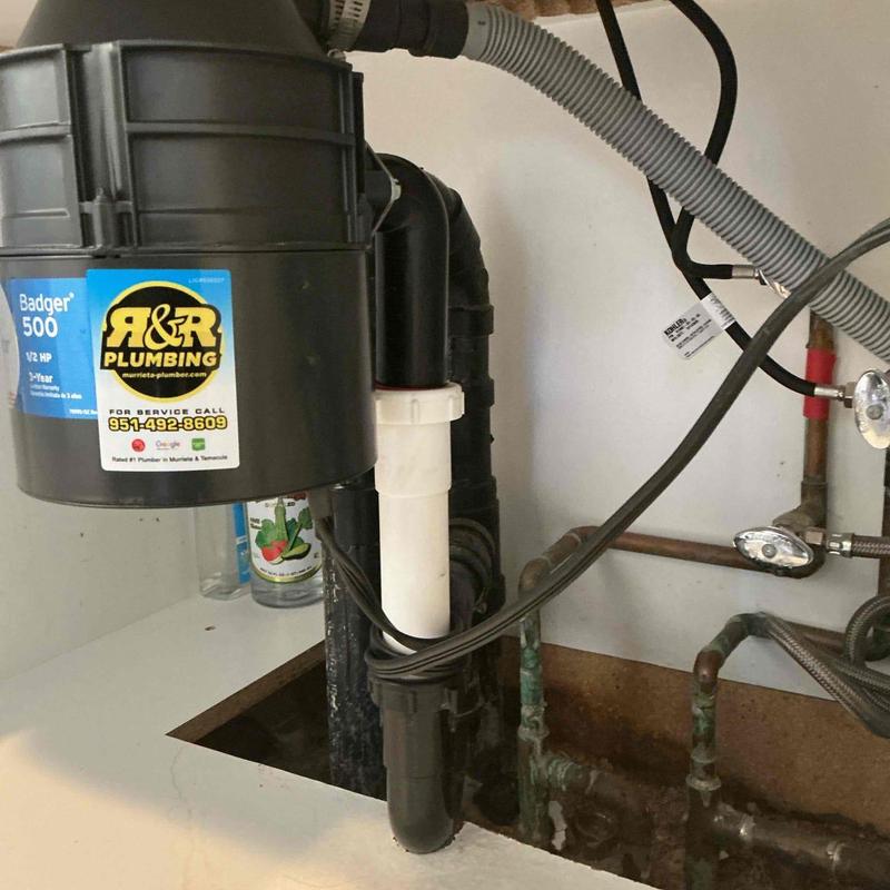 Tubular drain piping under kitchen sink with disposal unit