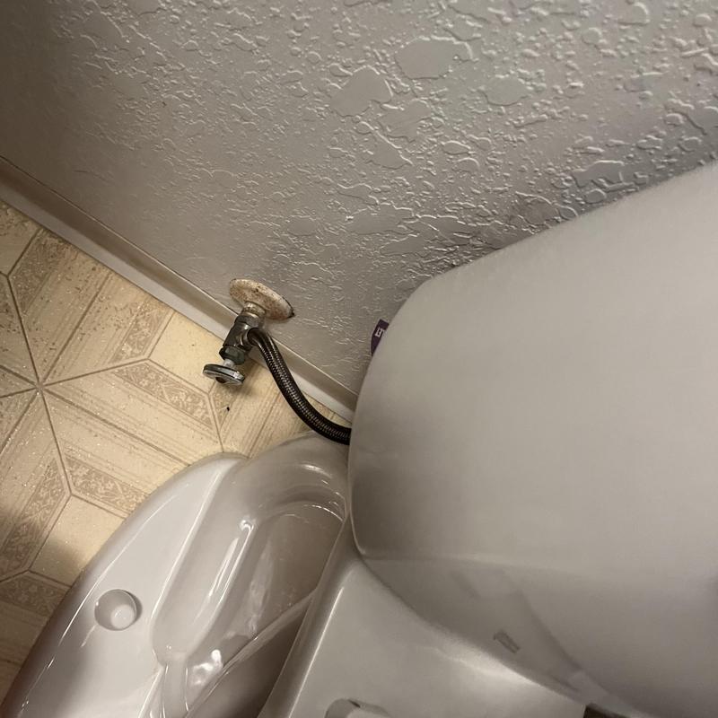 Toilet water supply line connection near wall flange
