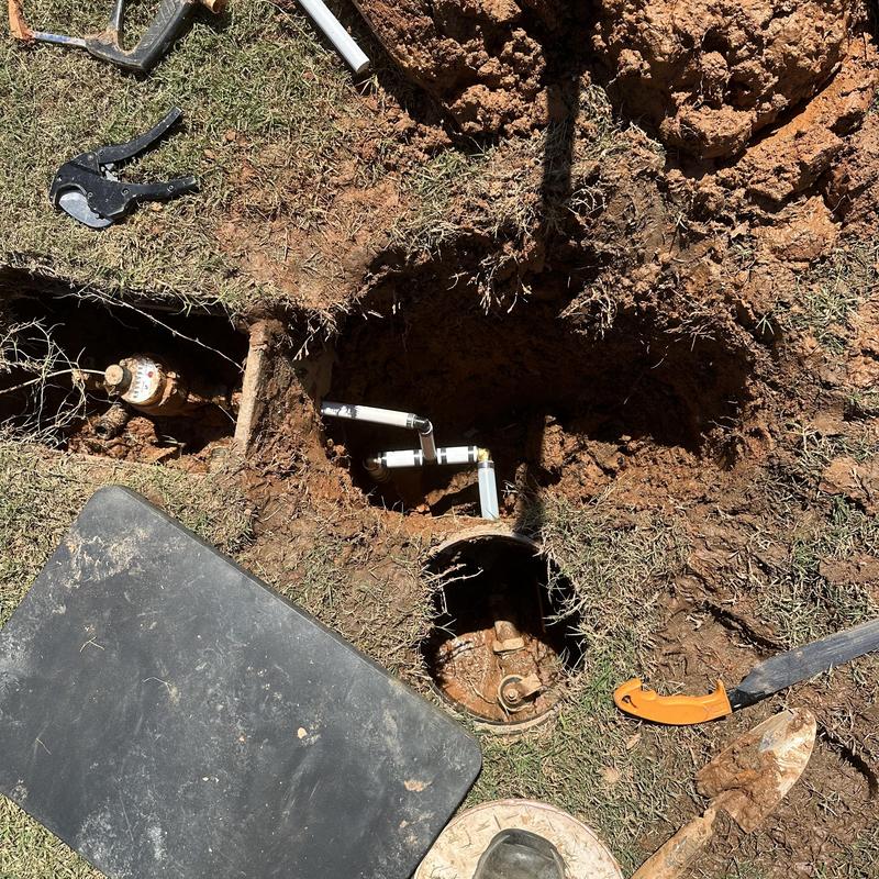 Main water line leak repair in yard with PVC fittings