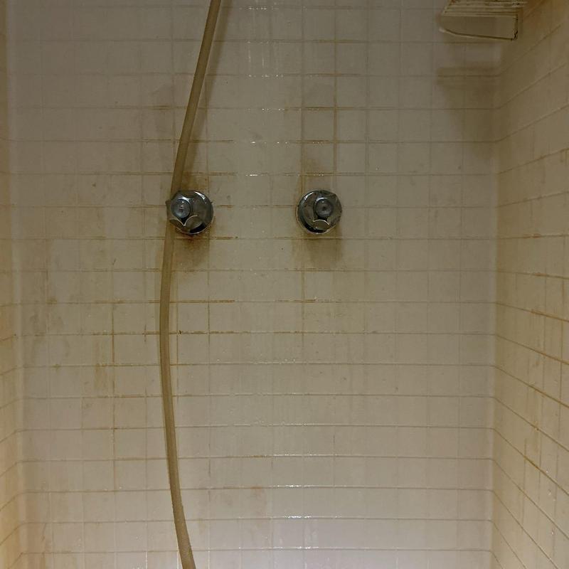 Shower valve stems and handles on tiled wall