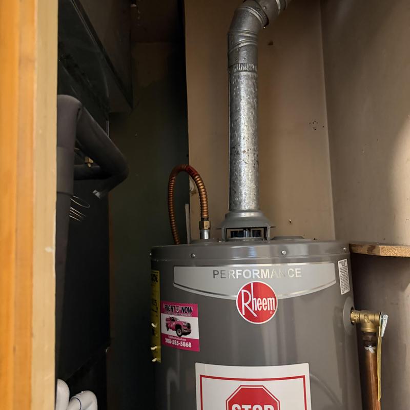Rheem water heater with vent pipe in utility closet