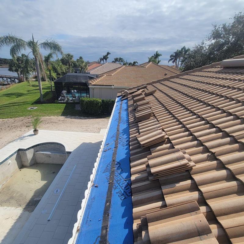 Tile roof eave with replaced decking and underlayment