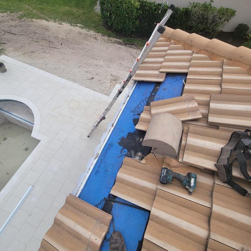 Tile roof eave with replaced decking and tools