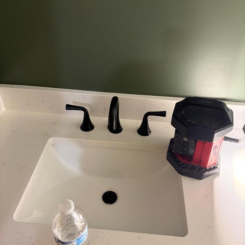 Bathroom sink faucet with installed fixtures and tools
