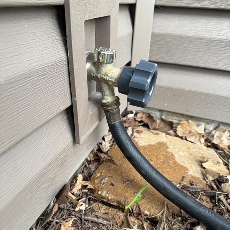 Outdoor water spigot with hose connection and valve handle