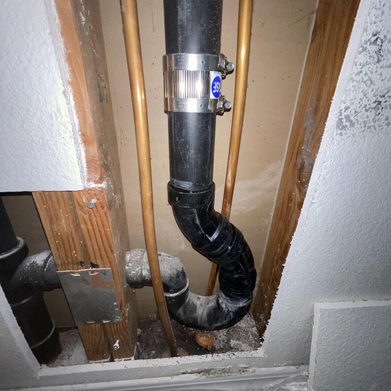 2-inch ABS drain pipe with repair band installation