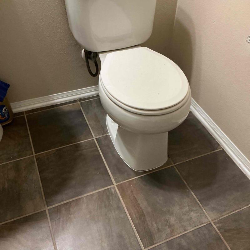 Toilet with new wax ring and base caulking installed