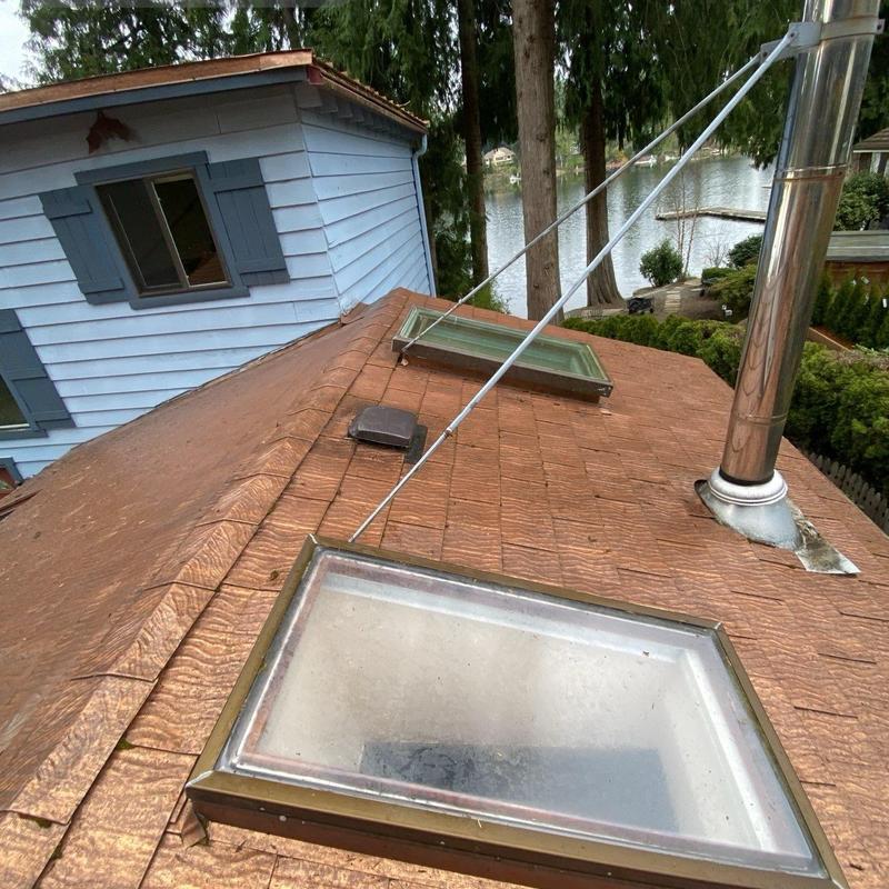 Skylights on shingle roof with chimney vent