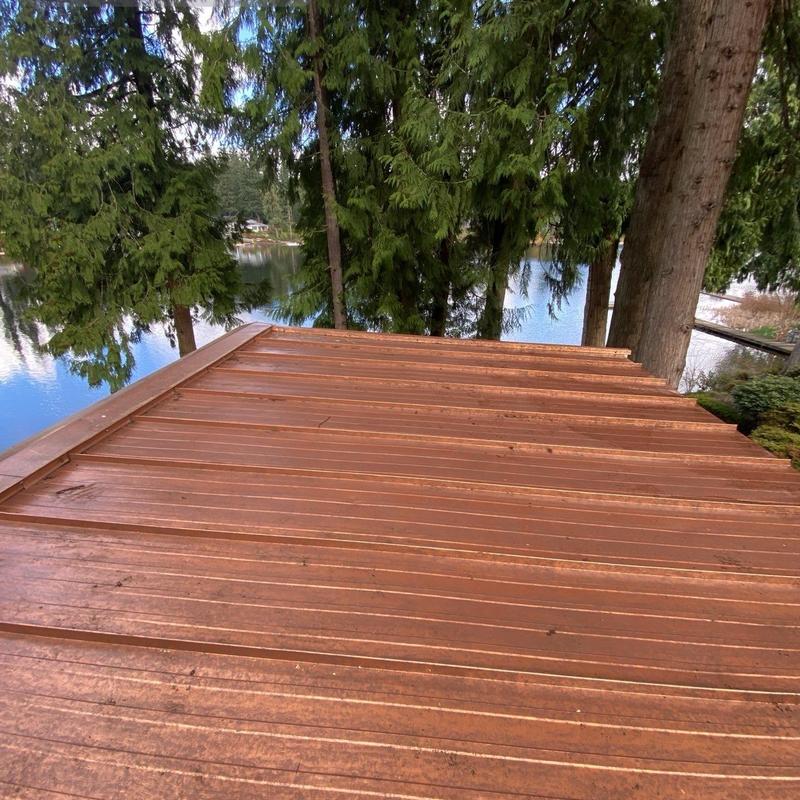 Wood deck surface cleaning near lake and trees