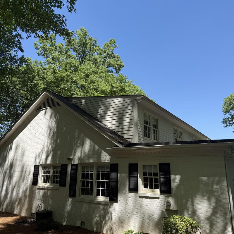 Roof-to-wall flashing and siding restoration on house exterior