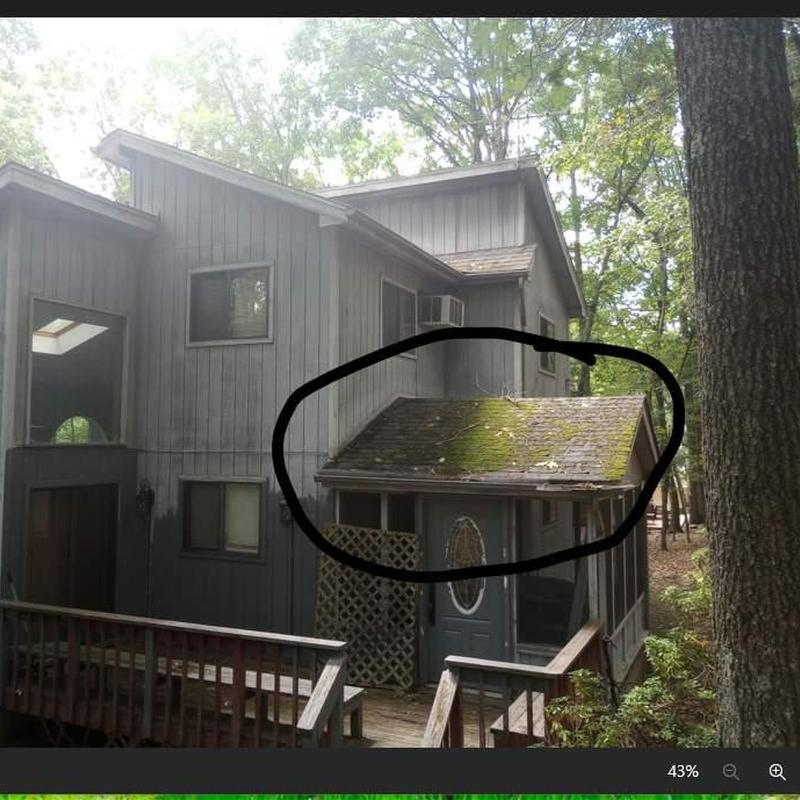Small roof section with moss and debris buildup Small roof section with moss and debris buildup