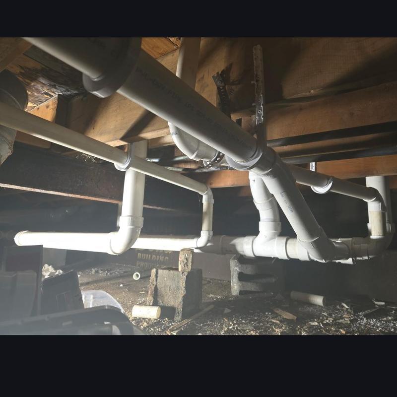 PVC drain pipes installation in crawl space plumbing system