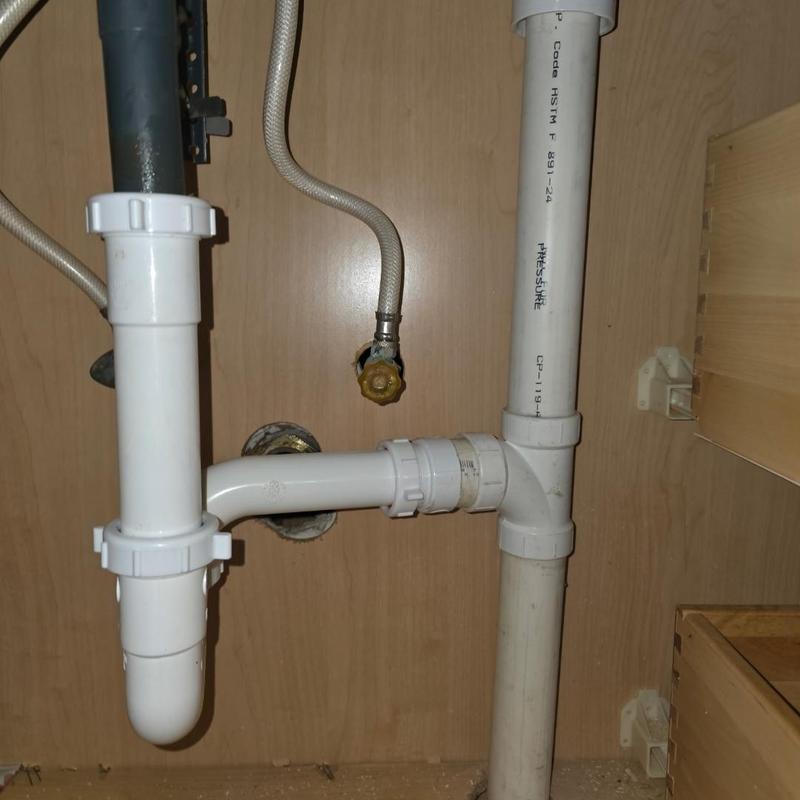 PVC drain pipe installation under sink cabinet
