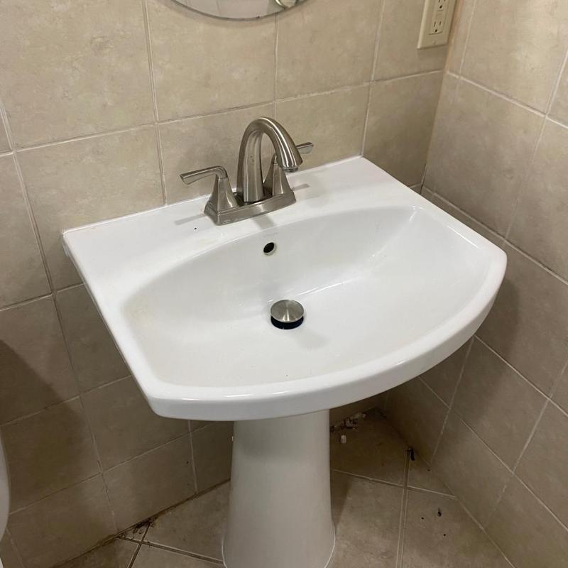 Pedestal sink installation with faucet and drain setup