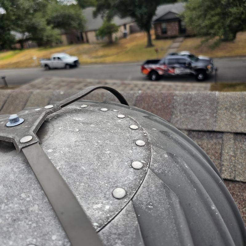 Metal roof vent with hail damage and dents