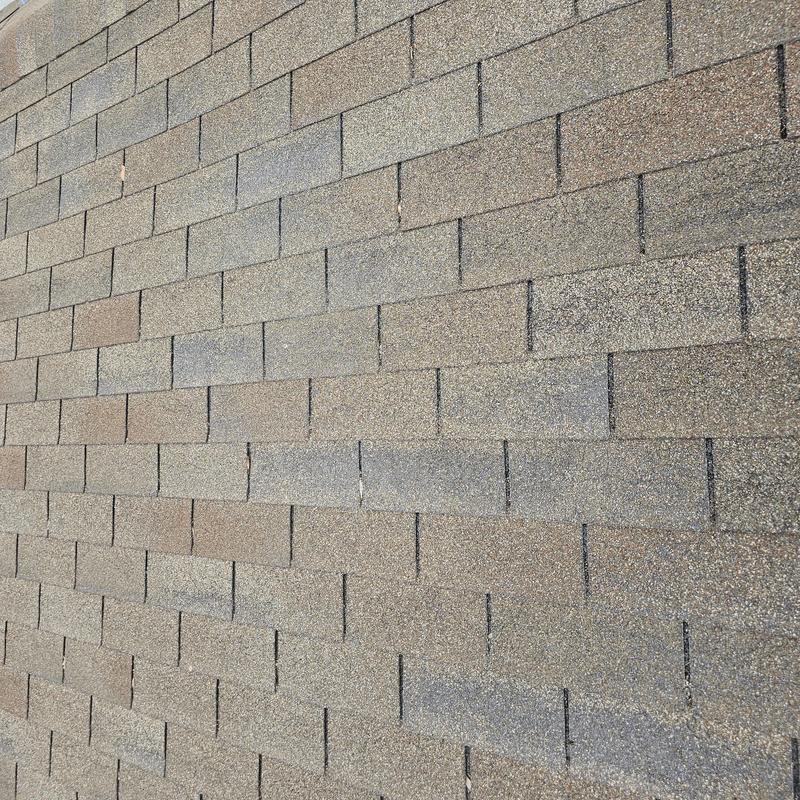 Asphalt roof shingles with hail damage close-up