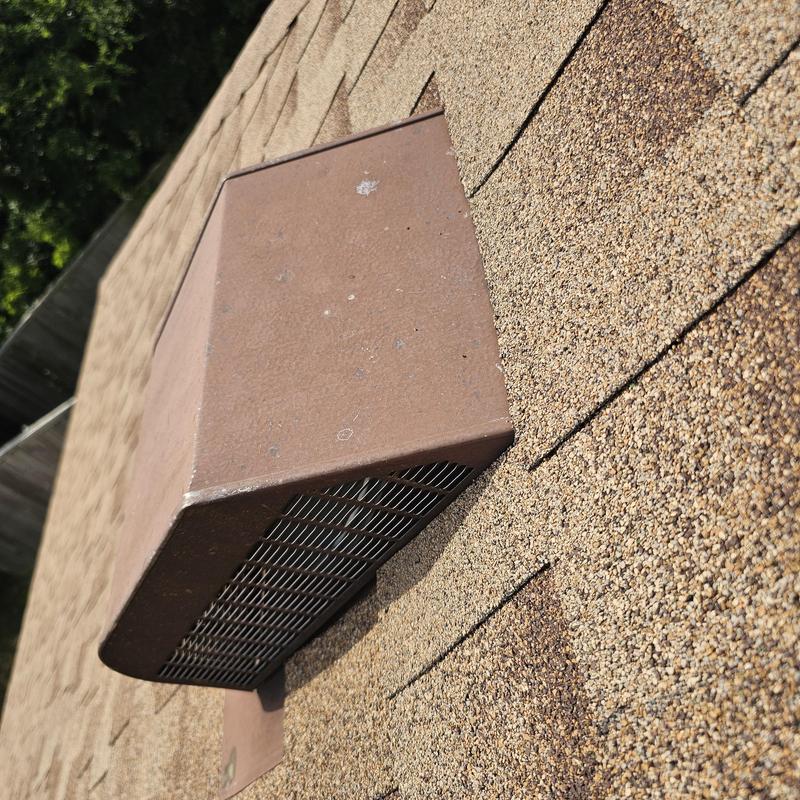 Roof vent with hail damage on asphalt shingles